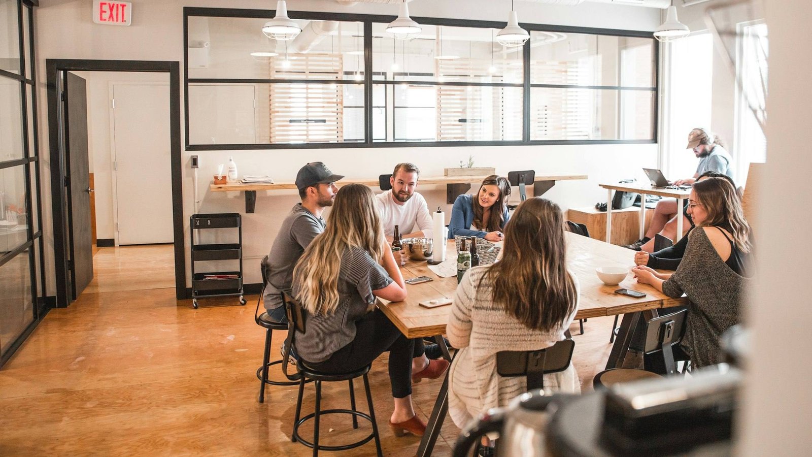 Colleagues working together at a large table in a bright office